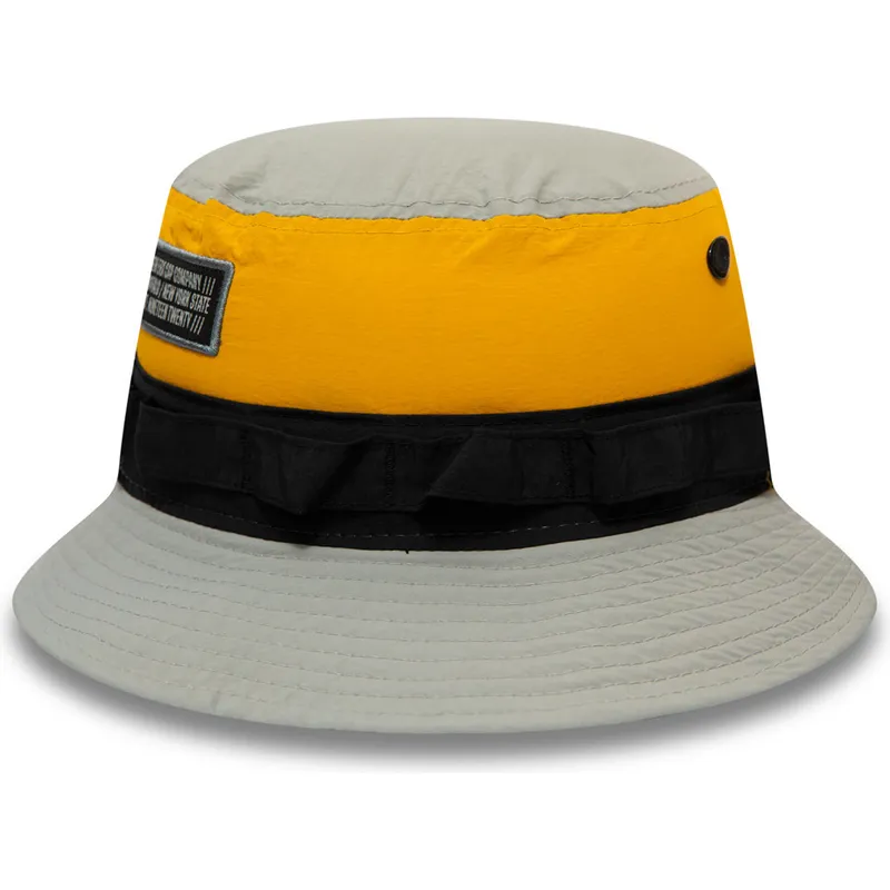 eimer-grau-der-bucket-gris-negro-y-amarillo-panelled-adventure-von-new-era eimer-grau-der-bucket-gris-negro-y-amarillo-panelled-adventure-von-new-era