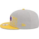 graue-und-gelbe-snapback-kappe-9fifty-draft-edition-2023-der-los-angeles-lakers-nba-von-new-era
